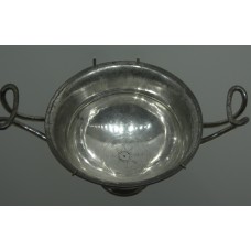 Eight-pointed cross design in the center of a drinking cup